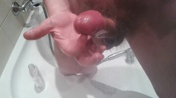 Playing with my oiled cock and cumming all over the mirror