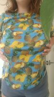 Titties dropping rom a big dumb pineapple shirt.